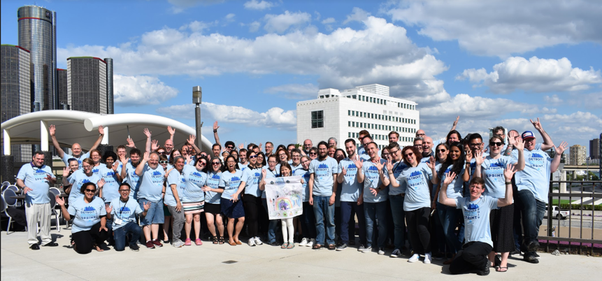 Group shot of about 60 sprint attendees in matching blue, sprint tshirts